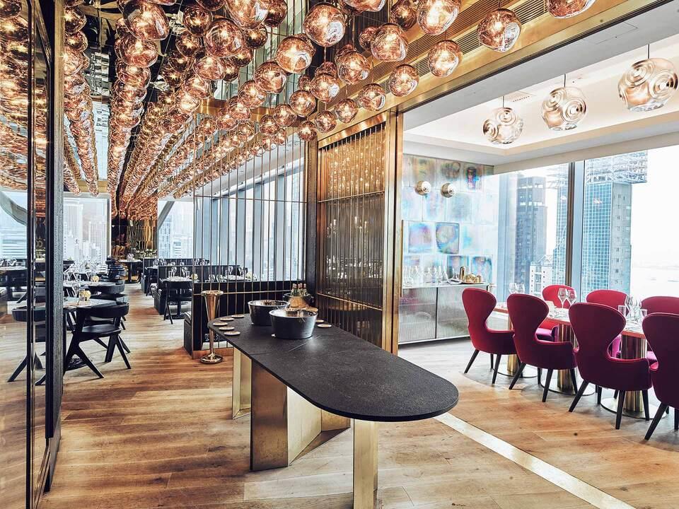 Spacious modern conference room with long table, designer ceiling lights and glass walls