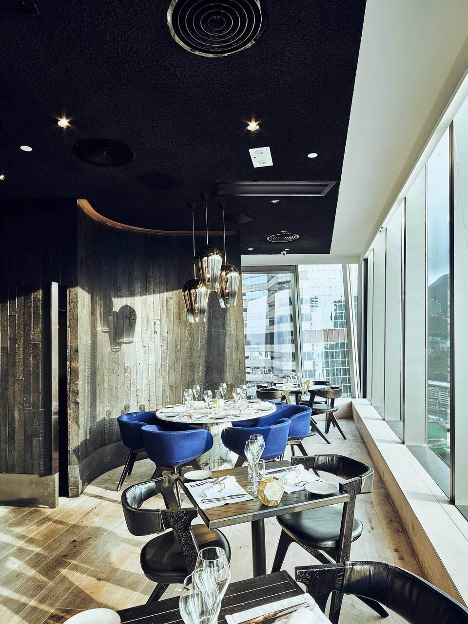 Modern restaurant dining area with elegant seating and large windows