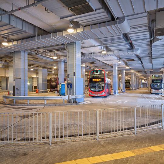 Entrance area of an underground parking garage with safety railings and concrete pillars