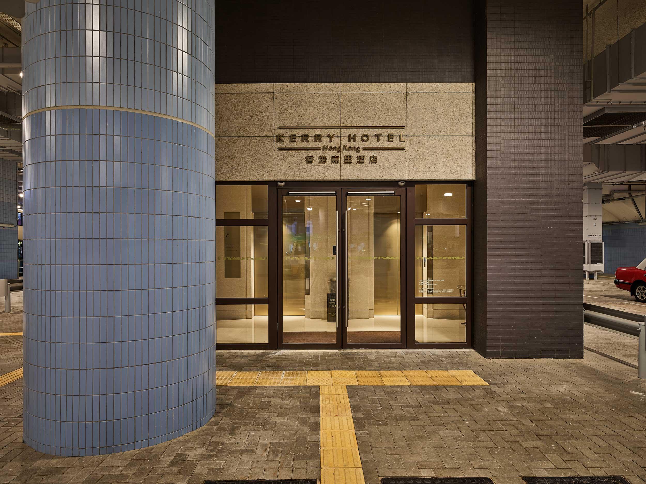 Entrance of an underground parking garage with glass doors and modern design