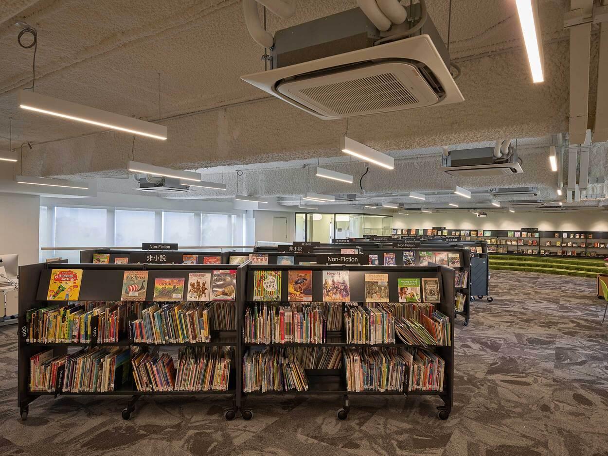 Bookshelves filled with books in a modern public library interior