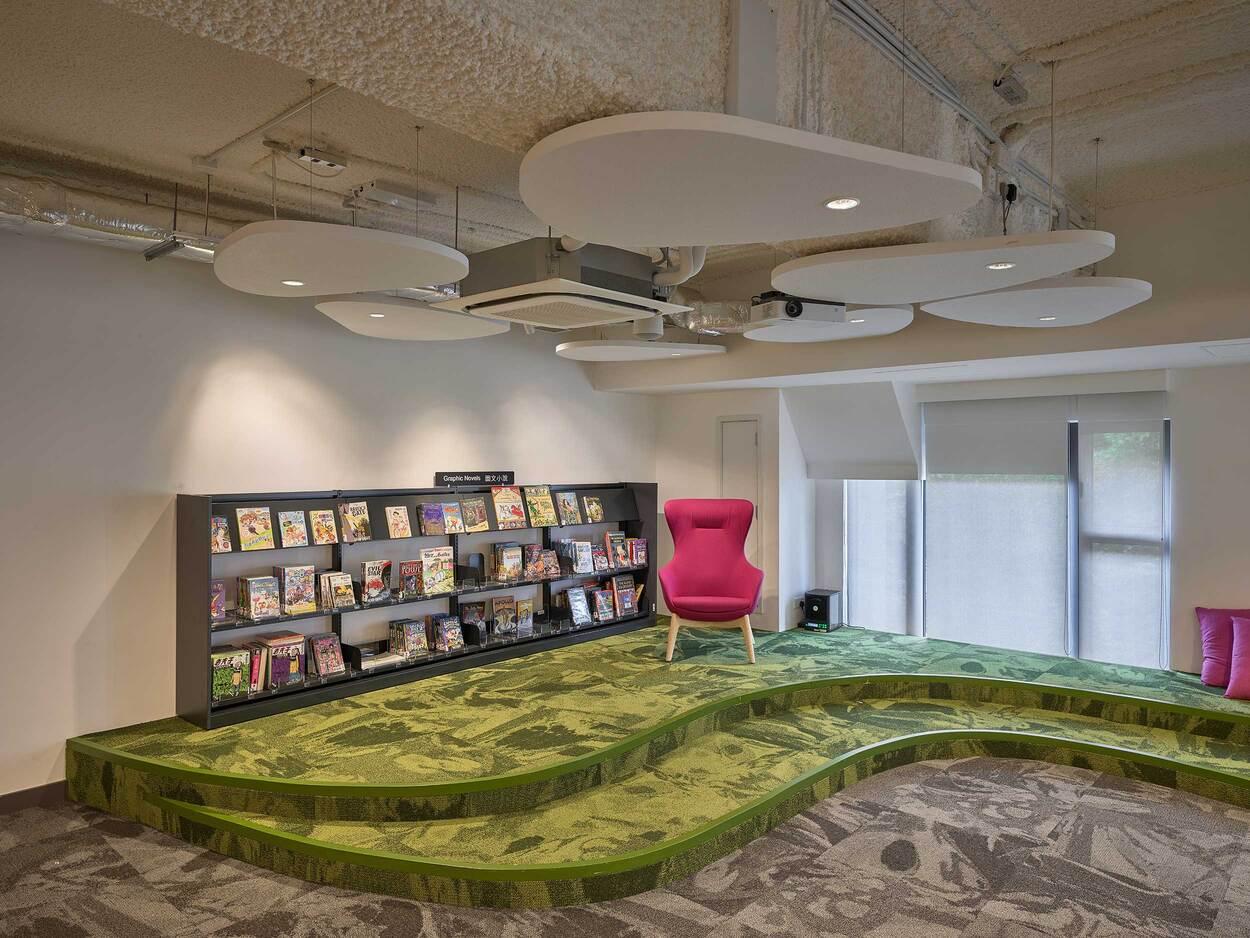 Creative library reading area with green carpet and bookshelves