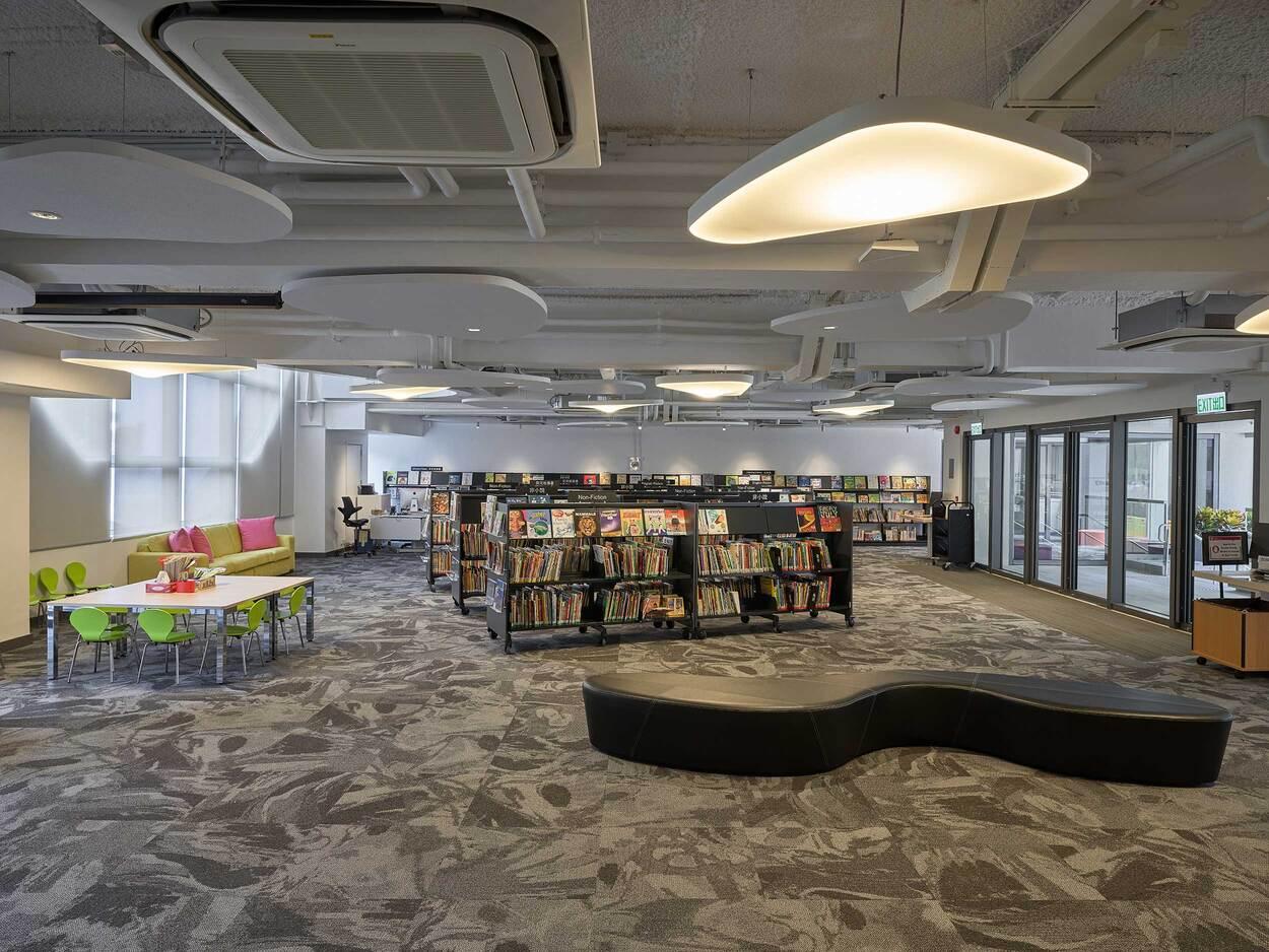 Spacious modern public library interior with seating area and bookshelves