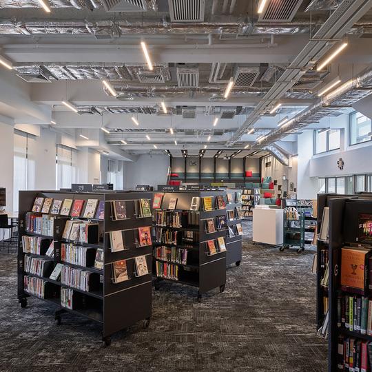 Rows of bookshelves in a modern library interior with natural light