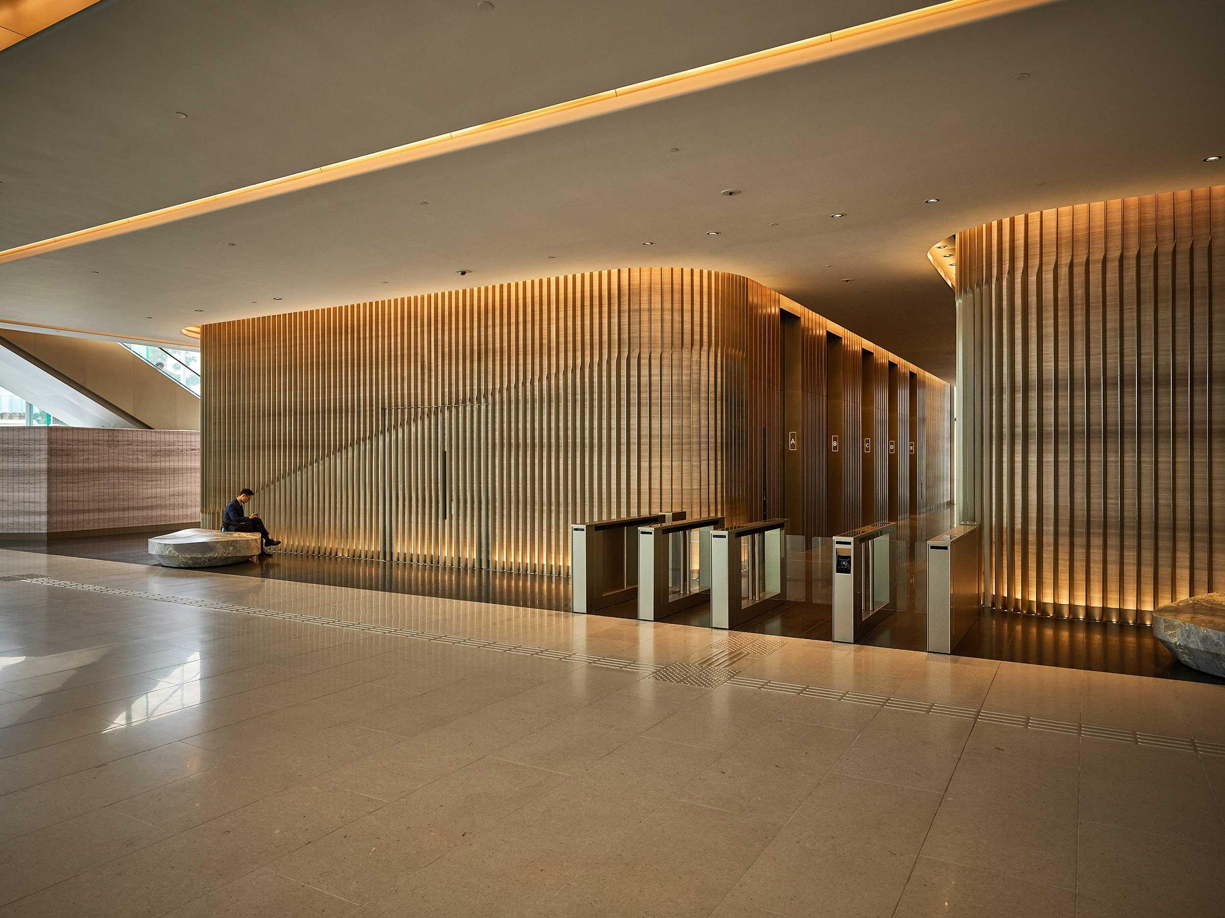 Spacious office lobby with reception desk and warm lighting design