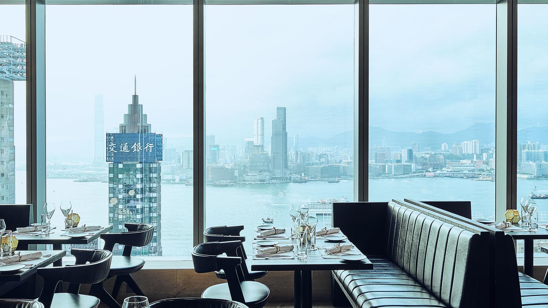 Restaurant interior with panoramic city skyline view through large windows