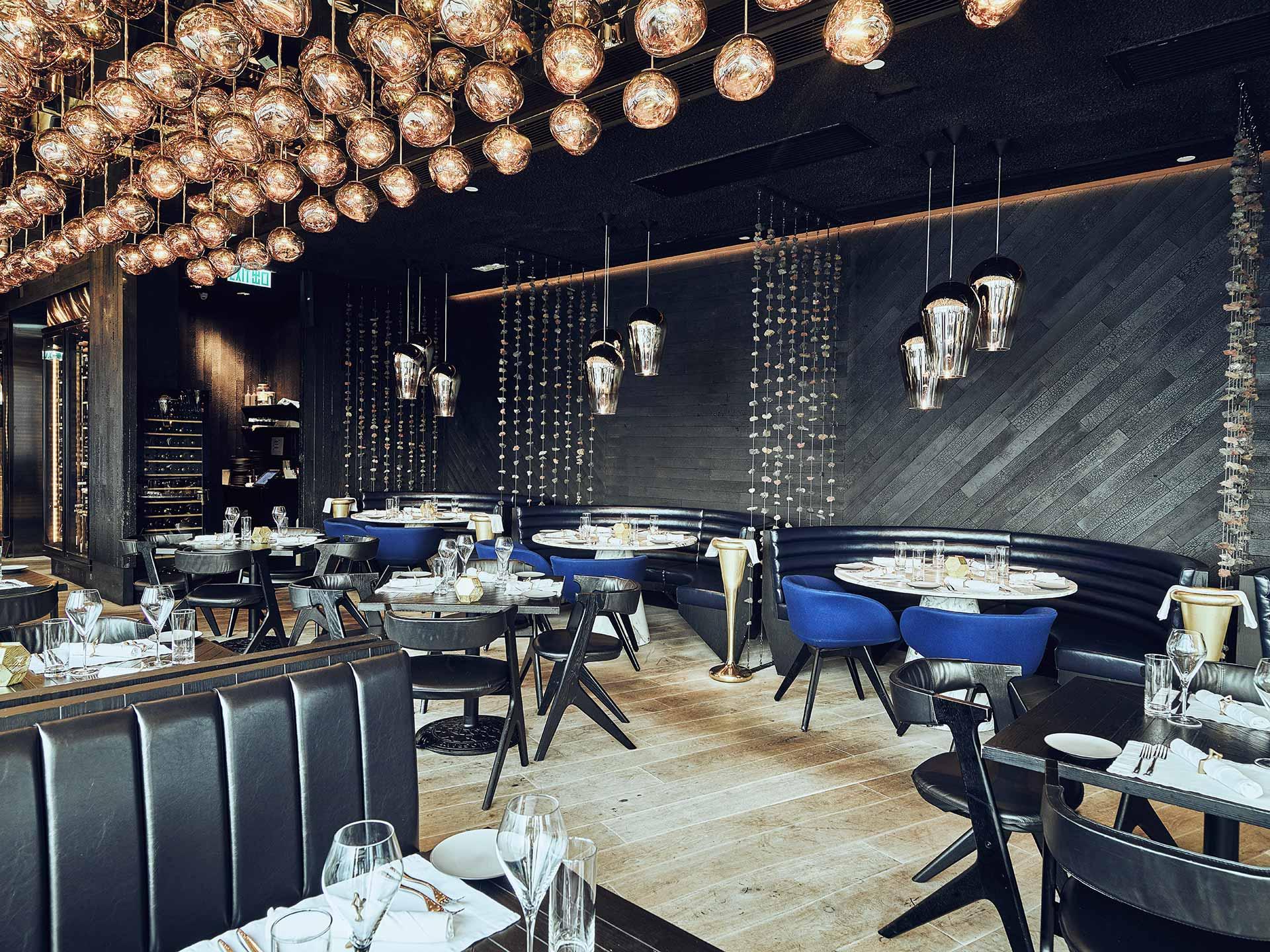 Stylish restaurant interior with decorative ceiling lights and dining tables