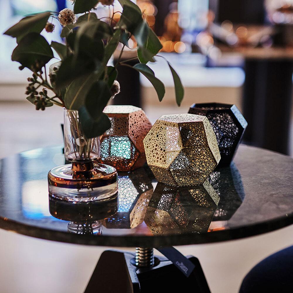 Close-up of decorative vases and plant on a round coffee table in modern interior