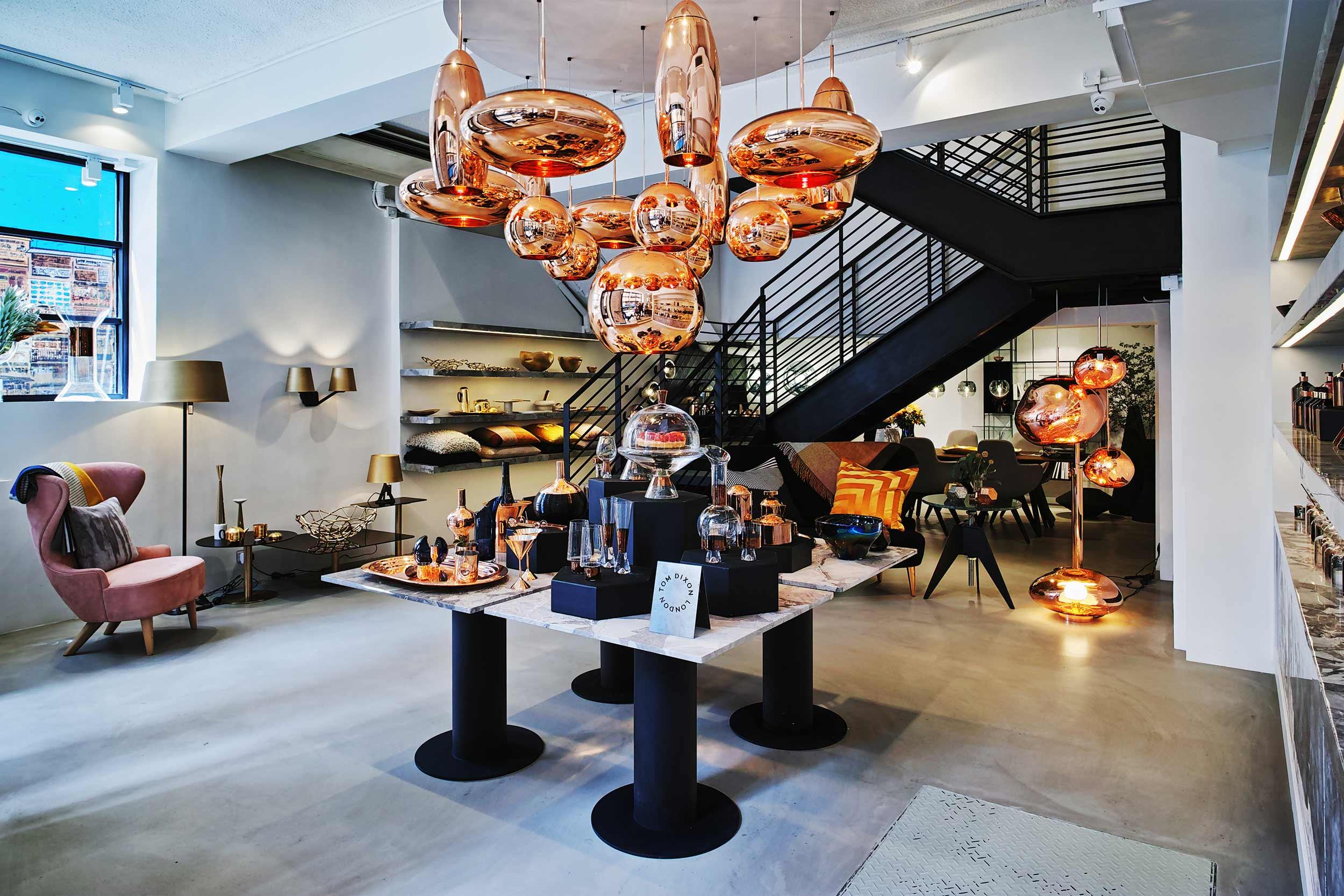 Interior view of Tom Dixon Hong Kong store with large pendant lighting and furniture displays
