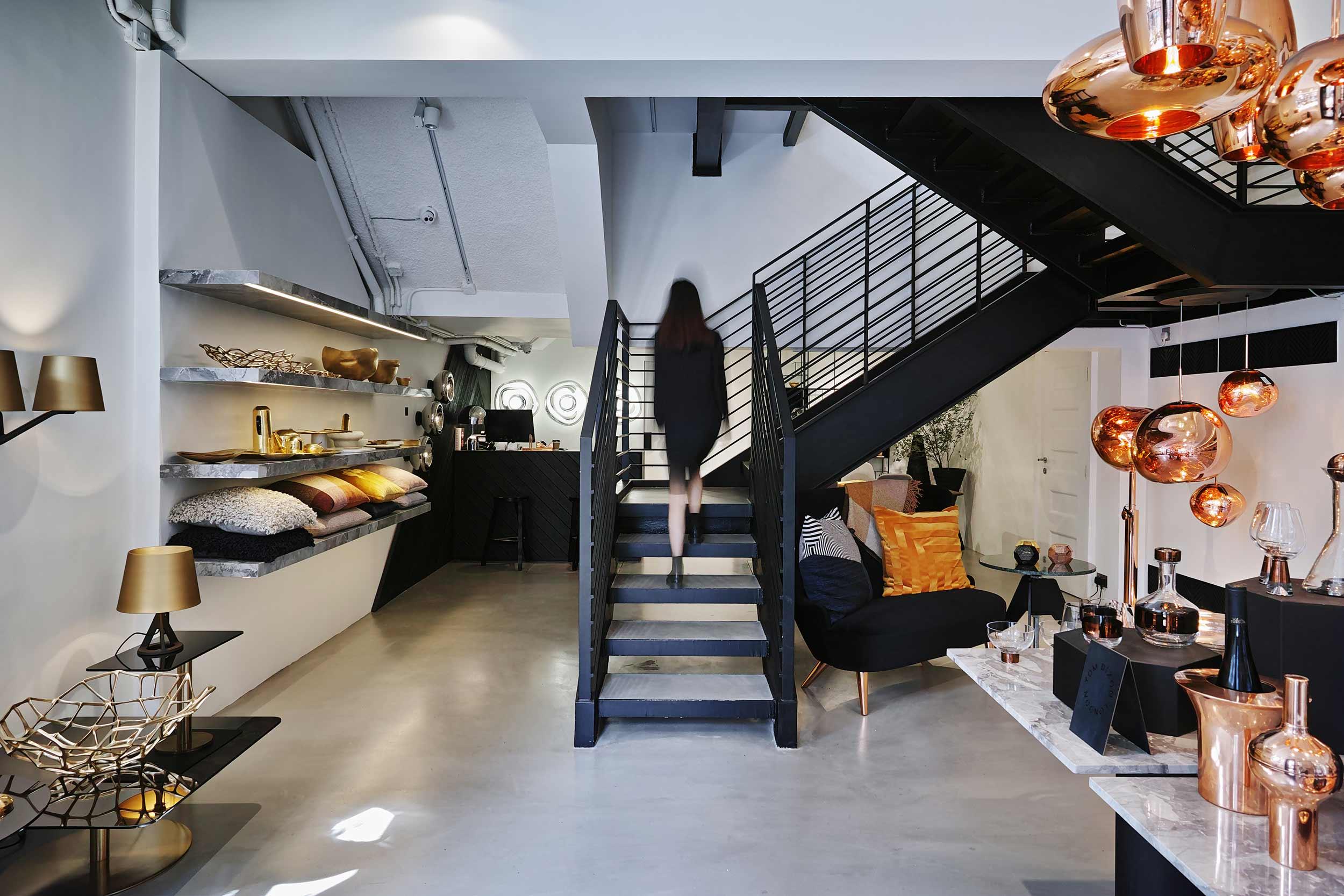 Interior view of Tom Dixon Hong Kong store with staircase, furniture, and lighting displays
