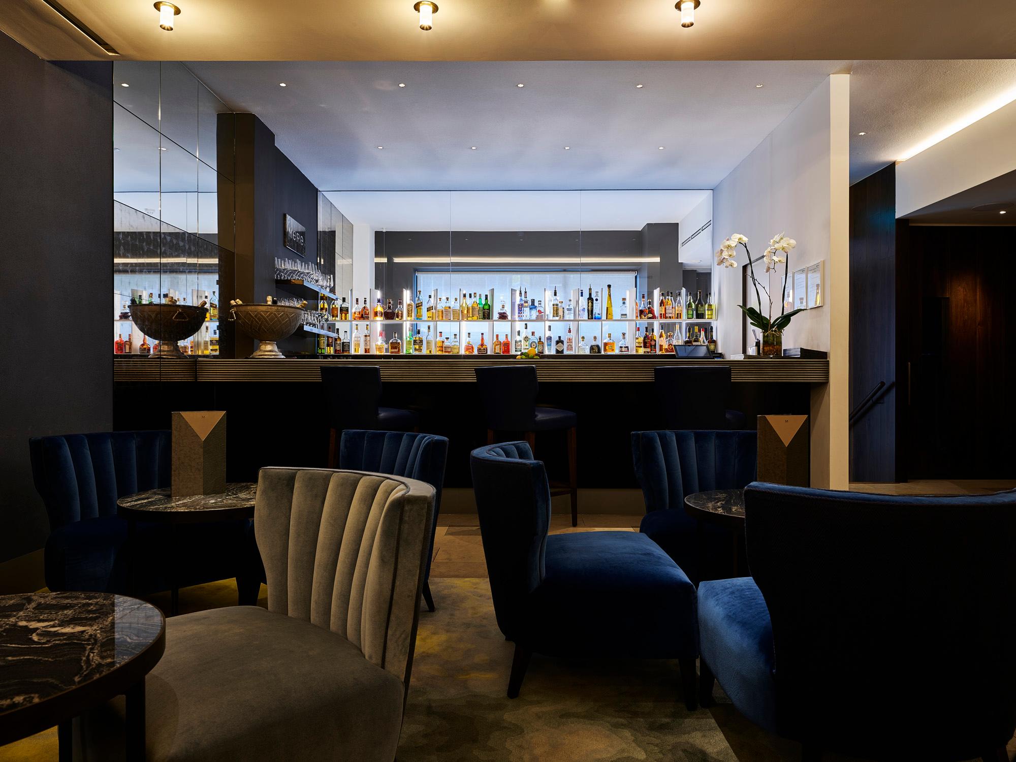 Stylish hotel bar lounge with acoustic ceiling panels, elegant lighting and seating area