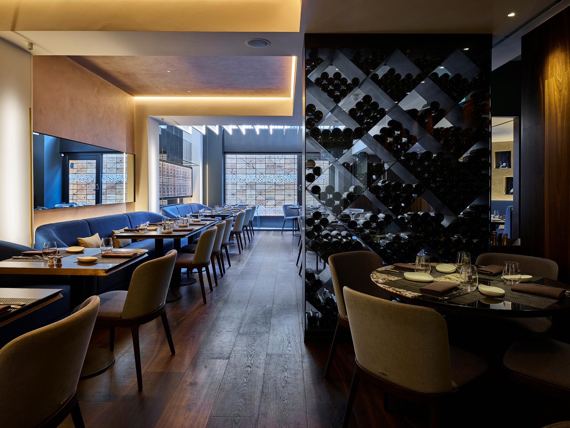 Modern restaurant dining area with Acosorb acoustic ceiling and elegant interior