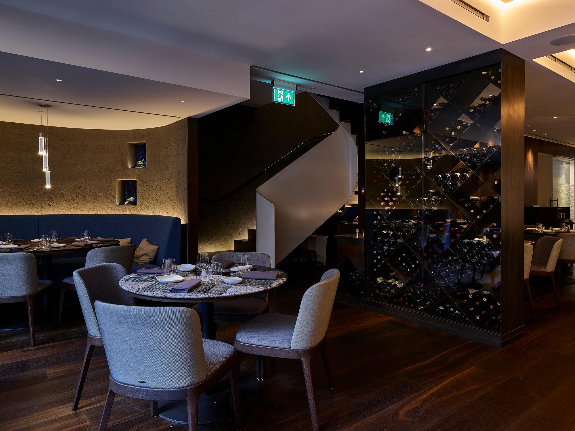 Elegant restaurant interior with Acosorb acoustic ceiling and stylish seating