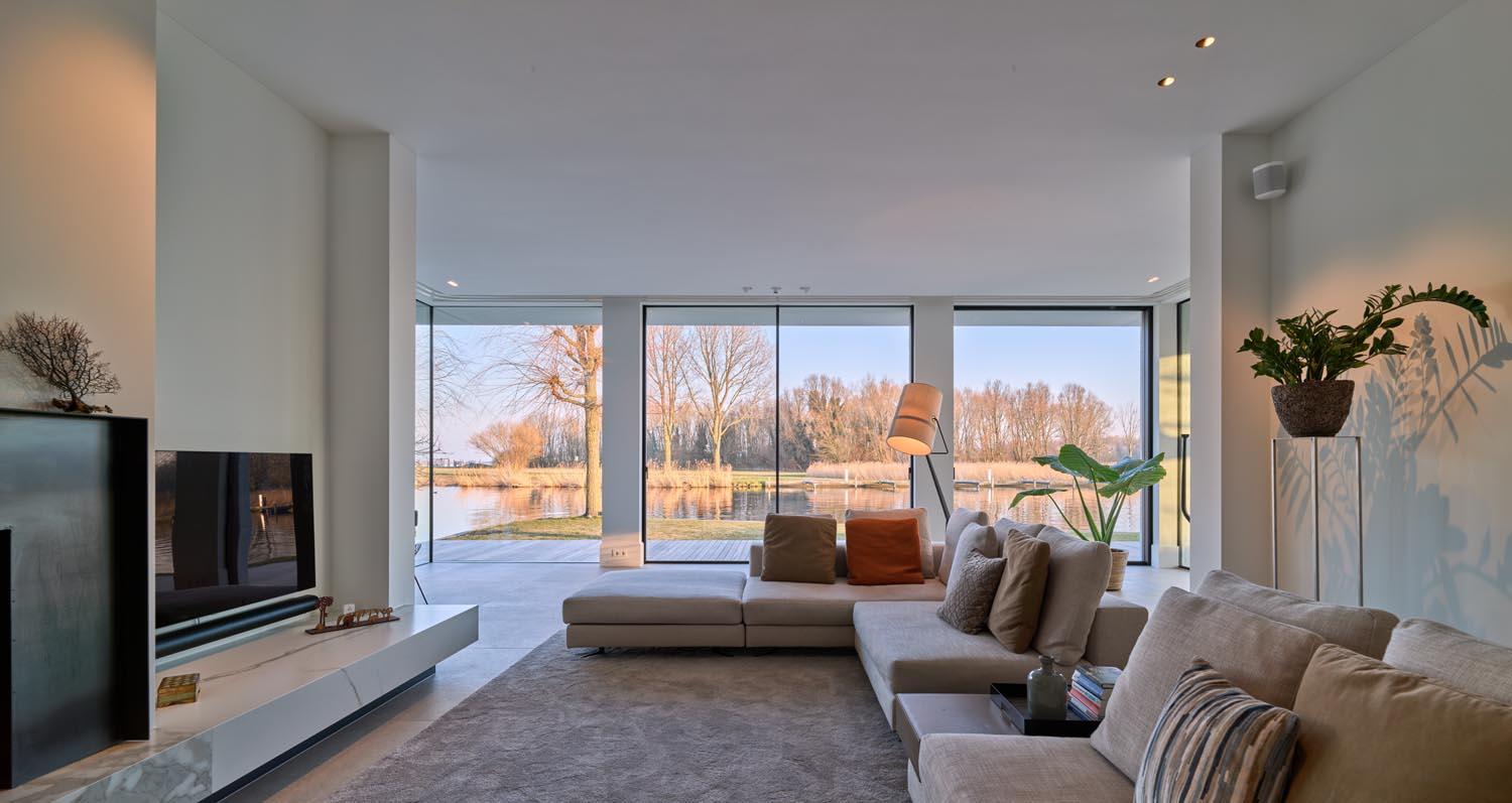 Spacious living room in Villa Warmond with Acosorb acoustic ceiling and large windows